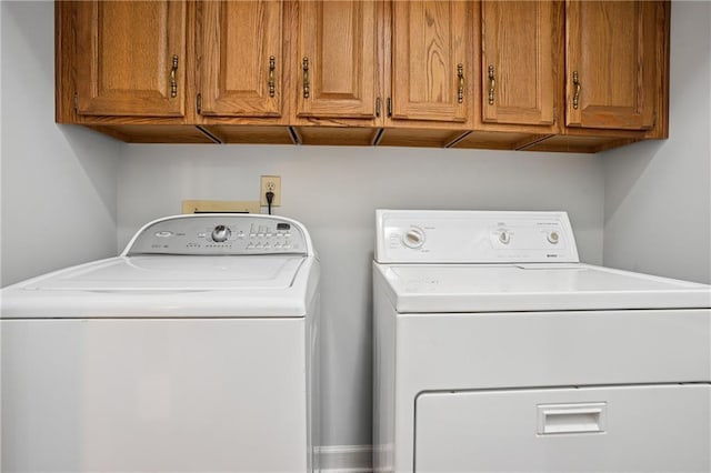 laundry room with cabinet space and separate washer and dryer