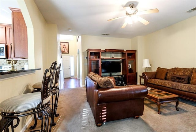 living room with light carpet and ceiling fan