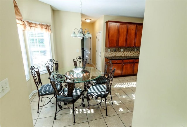 dining room with light tile patterned floors and an inviting chandelier