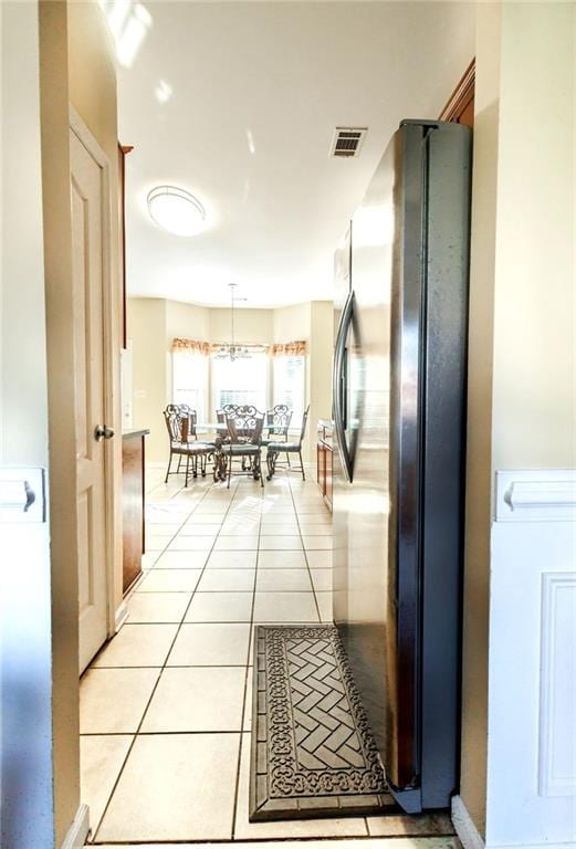 hall featuring light tile patterned flooring