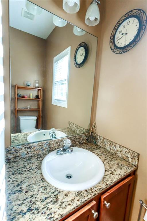 bathroom with vanity and toilet