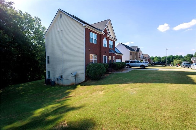 view of side of home with a yard