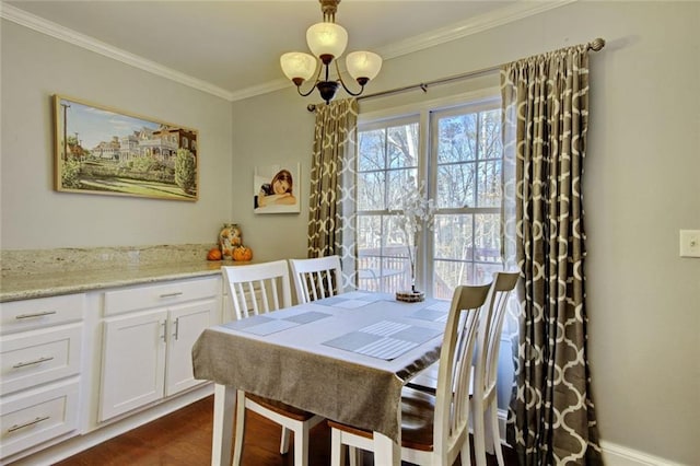 dining space featuring ornamental molding and an inviting chandelier