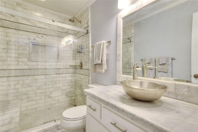 full bathroom with toilet, a stall shower, vanity, and crown molding