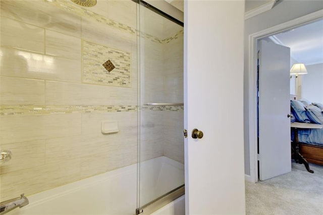 ensuite bathroom featuring ornamental molding, combined bath / shower with glass door, and connected bathroom