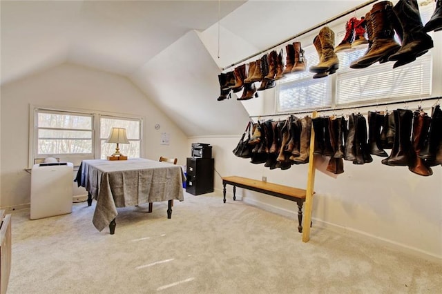 interior space with lofted ceiling and light colored carpet