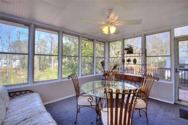 sunroom / solarium featuring ceiling fan