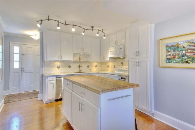 kitchen featuring white appliances, white cabinets, decorative backsplash, a kitchen island, and butcher block countertops