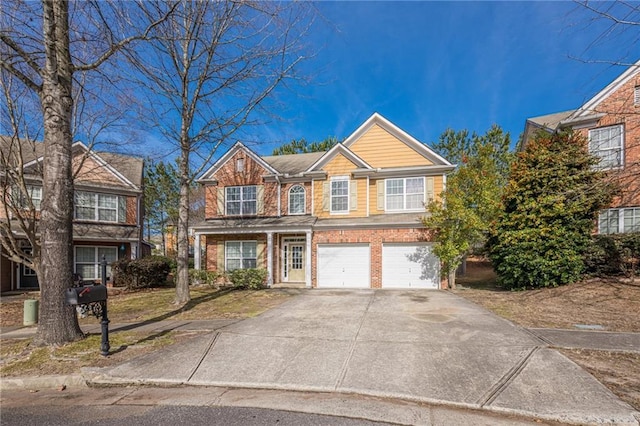 view of front facade with an attached garage, concrete driveway, and brick siding