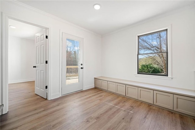 doorway to outside featuring light wood-style floors, recessed lighting, ornamental molding, and baseboards