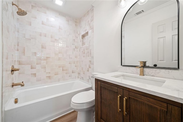 bathroom featuring toilet, visible vents, vanity, shower / bathing tub combination, and crown molding