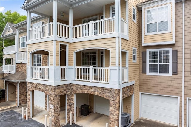 426 Pembrooke Cir Unit 426, Alpharetta, GA 30004 - view of home's exterior with an attached garage, stone siding, central air condition unit, and driveway