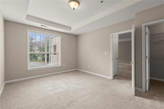 426 Pembrooke Cir Unit 426, Alpharetta, GA 30004 - unfurnished bedroom featuring carpet floors, a spacious closet, baseboards, a closet, and a raised ceiling