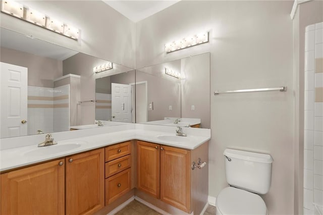 426 Pembrooke Cir Unit 426, Alpharetta, GA 30004 - bathroom featuring toilet, double vanity, tile patterned floors, and a shower