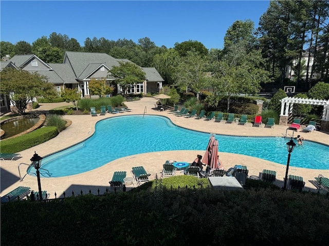 426 Pembrooke Cir Unit 426, Alpharetta, GA 30004 - community pool with a patio area, view of scattered trees, and a pergola