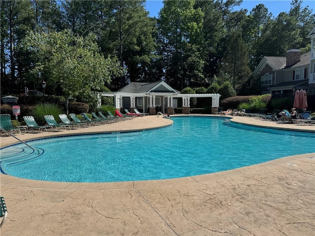 426 Pembrooke Cir Unit 426, Alpharetta, GA 30004 - community pool featuring a patio area and view of scattered trees
