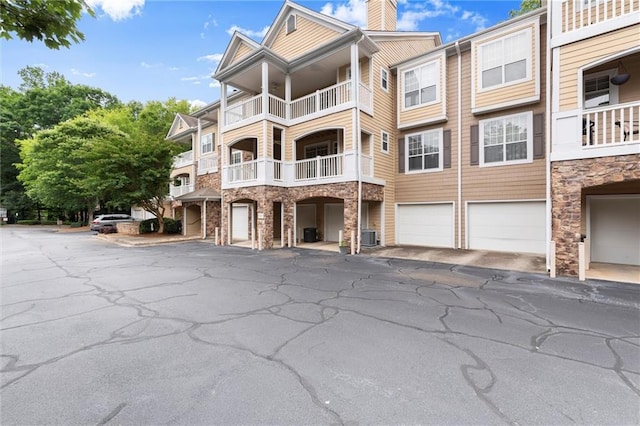 426 Pembrooke Cir Unit 426, Alpharetta, GA 30004 - view of building exterior featuring an attached garage and driveway
