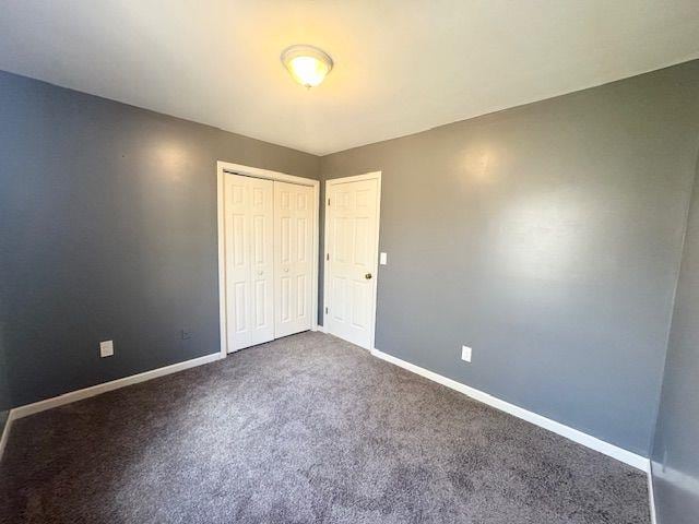 unfurnished bedroom featuring a closet and carpet