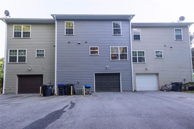 rear view of house with a garage