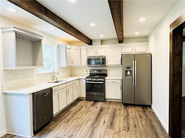 kitchen featuring appliances with stainless steel finishes, sink, and white cabinets