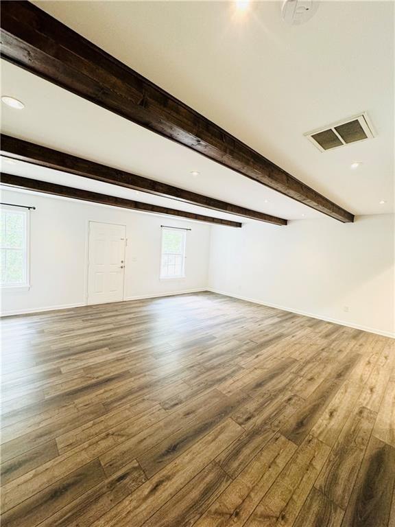 interior space featuring hardwood / wood-style flooring and beamed ceiling