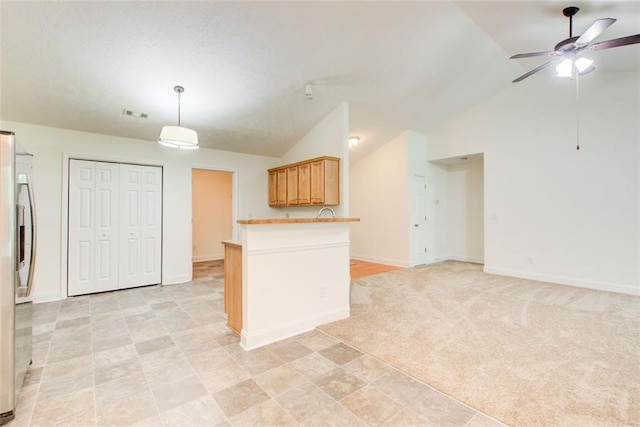 221 Glenview Trl, Griffin, GA 30224 - kitchen with stainless steel refrigerator with ice dispenser, lofted ceiling, a ceiling fan, a peninsula, and decorative light fixtures