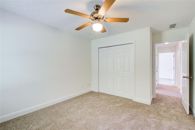 221 Glenview Trl, Griffin, GA 30224 - unfurnished bedroom with light colored carpet, a closet, and a ceiling fan