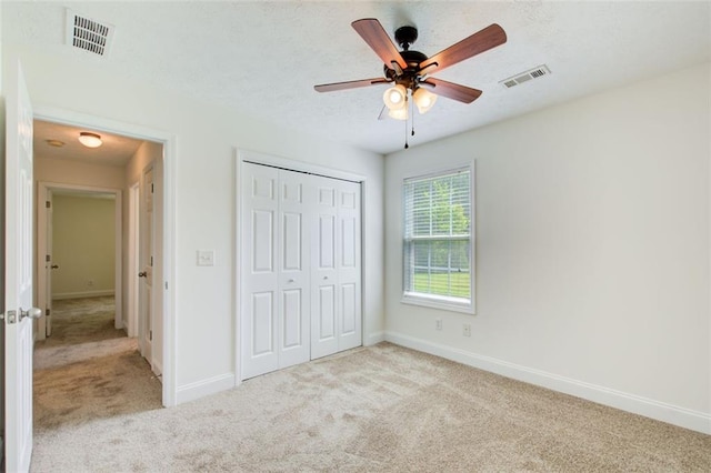 221 Glenview Trl, Griffin, GA 30224 - unfurnished bedroom featuring carpet floors, a closet, ceiling fan, and a textured ceiling
