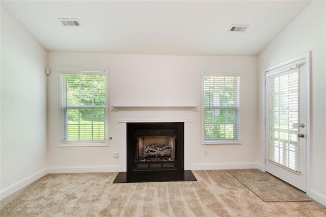 221 Glenview Trl, Griffin, GA 30224 - unfurnished living room with plenty of natural light, carpet, and a fireplace with flush hearth