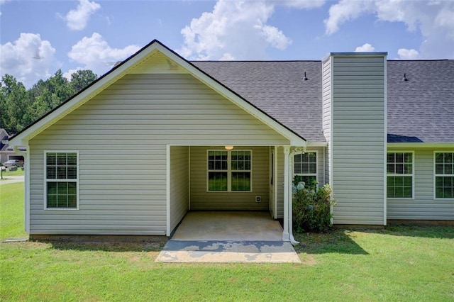 221 Glenview Trl, Griffin, GA 30224 - rear view of house featuring a shingled roof, a yard, a chimney, and a patio