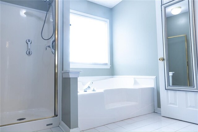 bathroom with plenty of natural light, separate shower and tub, and tile patterned floors