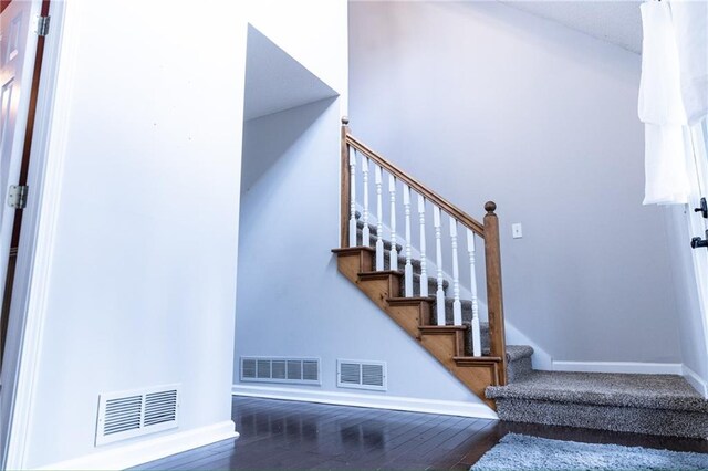 staircase with hardwood / wood-style flooring