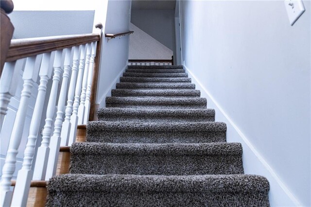 stairway with hardwood / wood-style floors