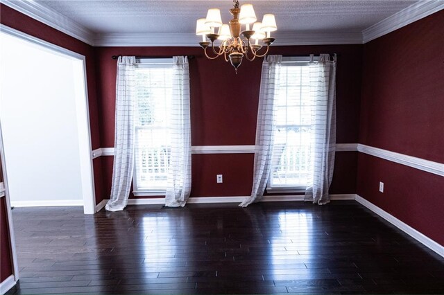 unfurnished room with a notable chandelier, crown molding, dark hardwood / wood-style flooring, and a textured ceiling