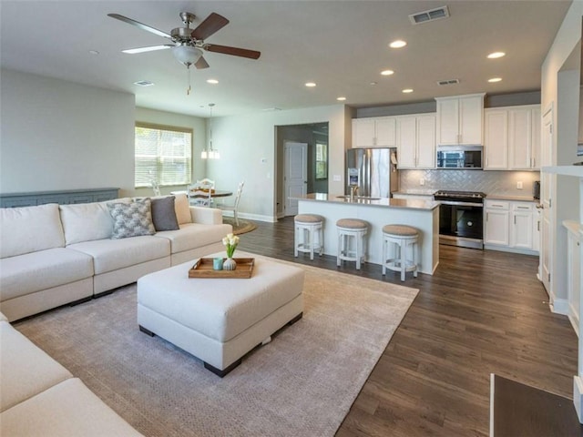360 Hayden Cir, Woodstock, GA 30189 - living area with recessed lighting, ceiling fan, dark wood-type flooring, and baseboards