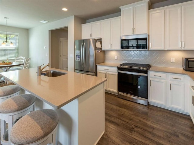 360 Hayden Cir, Woodstock, GA 30189 - kitchen with stainless steel appliances, a sink, recessed lighting, dark wood-type flooring, and backsplash