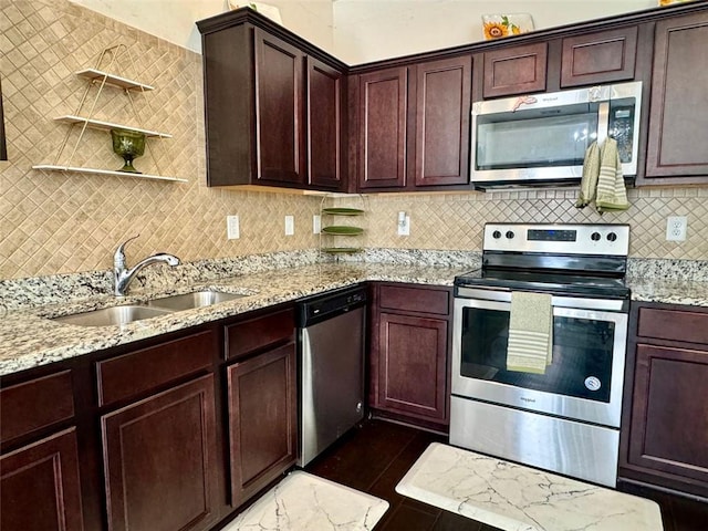 1606 Larkspur Trl, Conyers, GA 30012 - kitchen featuring appliances with stainless steel finishes, a sink, open shelves, light stone countertops, and tasteful backsplash