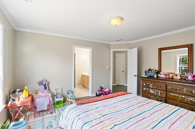 bedroom featuring baseboards, crown molding, and ensuite bath