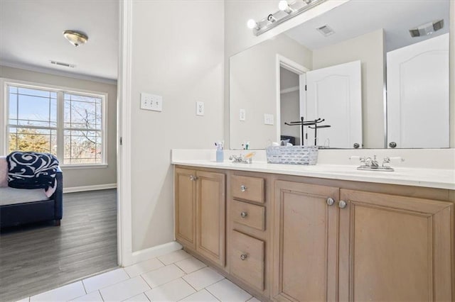 ensuite bathroom featuring tile patterned flooring, visible vents, a sink, and double vanity