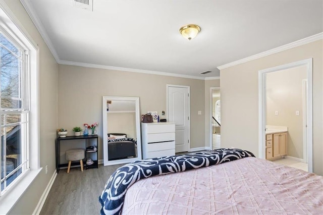 bedroom featuring crown molding, baseboards, and wood finished floors