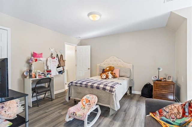 bedroom featuring dark wood-style floors and baseboards