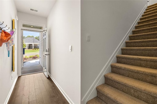 stairway with dark wood-type flooring