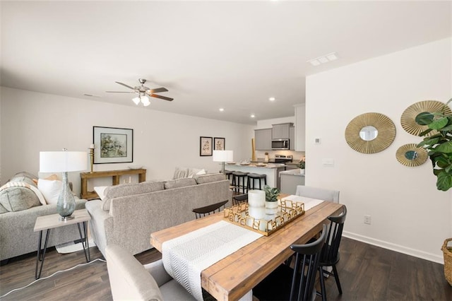 dining space with dark wood-type flooring and ceiling fan