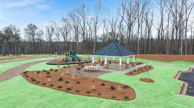 view of community featuring a playground, a gazebo, and a lawn