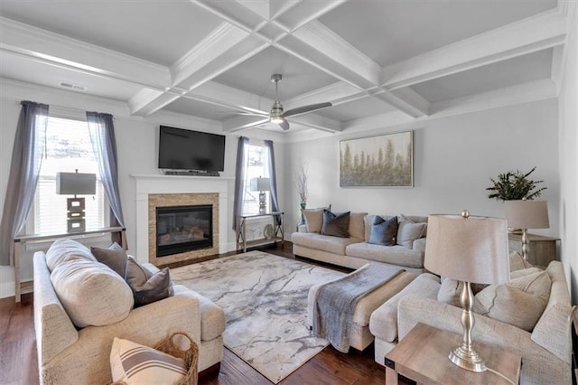 2953 Balvenie Pl, Acworth, GA 30101 - living room with a ceiling fan, healthy amount of natural light, a glass covered fireplace, dark wood finished floors, and beamed ceiling