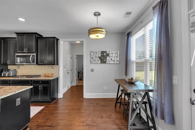2953 Balvenie Pl, Acworth, GA 30101 - kitchen with appliances with stainless steel finishes, dark cabinetry, baseboards, dark wood-type flooring, and decorative backsplash
