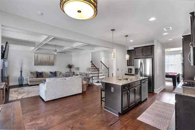 2953 Balvenie Pl, Acworth, GA 30101 - kitchen featuring a sink, light stone counters, a breakfast bar area, open floor plan, and recessed lighting