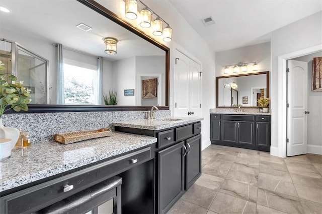 2953 Balvenie Pl, Acworth, GA 30101 - full bath featuring two vanities, a stall shower, and baseboards