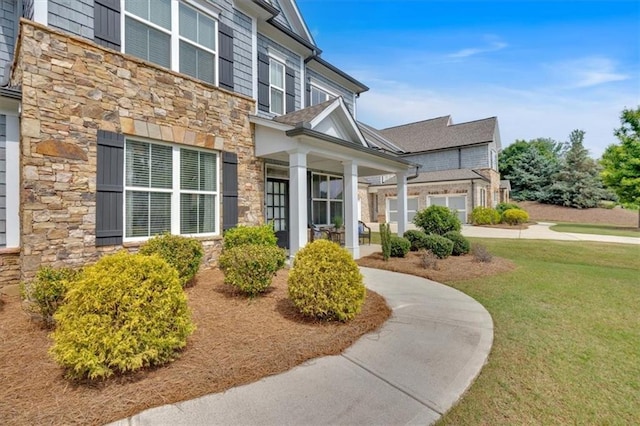 2953 Balvenie Pl, Acworth, GA 30101 - view of side of property featuring stone siding, a yard, and covered porch