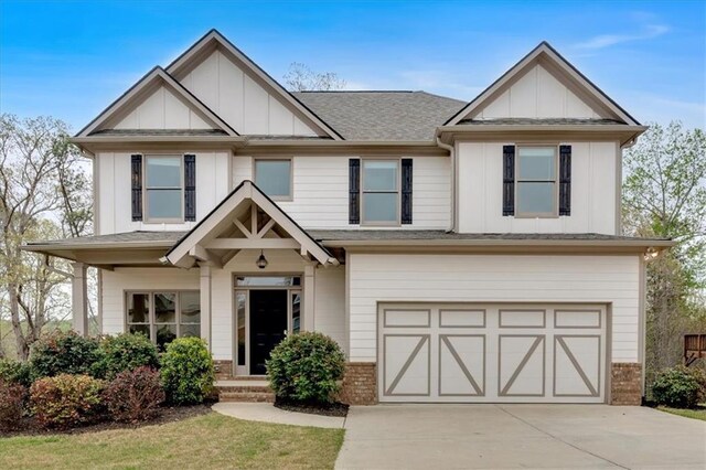822 Pine Way, Dallas, GA 30157 - view of front of property featuring a garage, brick siding, board and batten siding, driveway, and a shingled roof